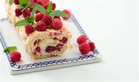 Premium Photo Baked Meringue Roll With Cream And Fresh Red Raspberry