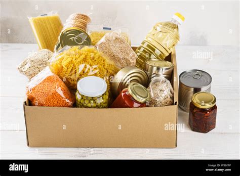 Various Canned Food Pasta And Cereals In A Cardboard Box Food