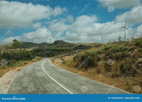 Road And Wind Turbines For Electric Power Generation Over Hills Stock