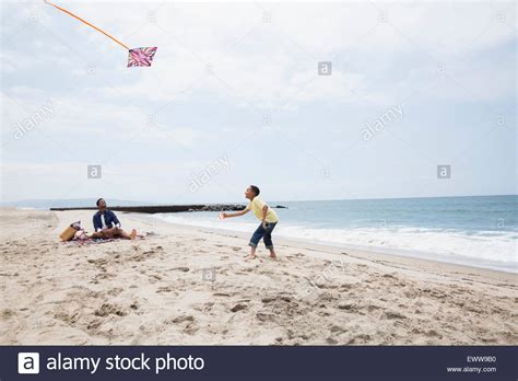 Father And Son Flying Kite On Beach Stock Photo Alamy