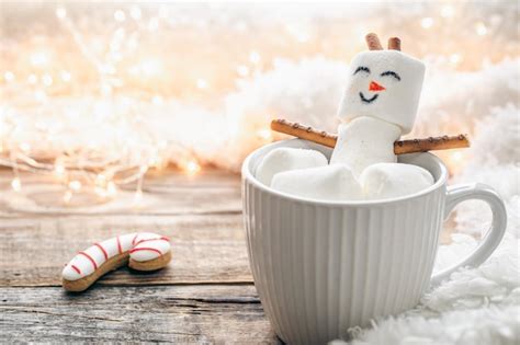 Free Photo Close Up Mug Of Hot Drink With Marshmallow Snowman On Blurred Background