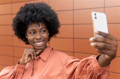 Free Photo African American Woman Taking A Selfie With Her Smartphone