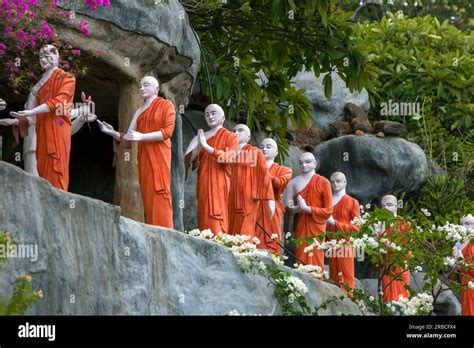 A Row Of Buddhist Monk Statues Adjacent To The Golden Temple At