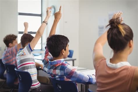 Premium Photo | Student raising hand in classroom