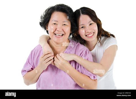 Portrait Of Asian Adult Daughter Hugging Senior Mother And Smiling