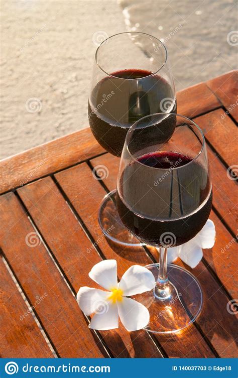 Relaxing Beach Scene Two Glasses Of Red Wine At Sunset Near Water Stock Image Image Of