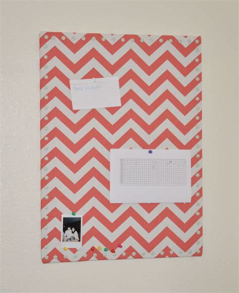 an orange and white chevroned bulletin board with magnets on the bottom half