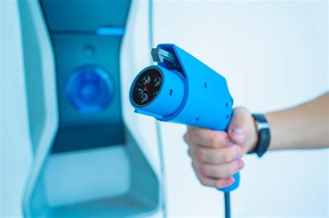 Premium Photo Man Charge His Electric Car At City Charging Station