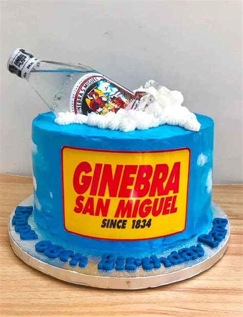 A Birthday Cake With A Bottle Of Ginebra In The Middle And Frosting On Top