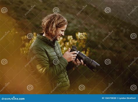 Smiling Male Photographer Check Photos On Camera Stock Photo Image Of