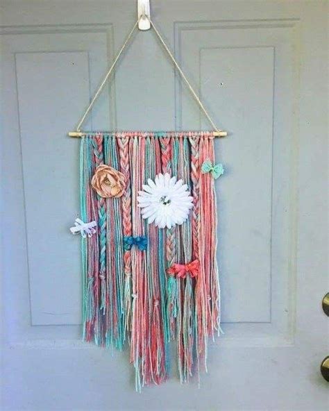 A Colorful Wall Hanging With Flowers And Ribbons On It S Front Door Hanger