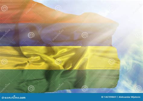 Mauritius Waving Flag Against Blue Sky With Sunrays Stock Image Image