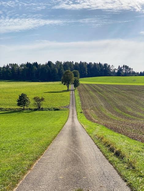 Premium Photo Road Amidst Field Against Sky