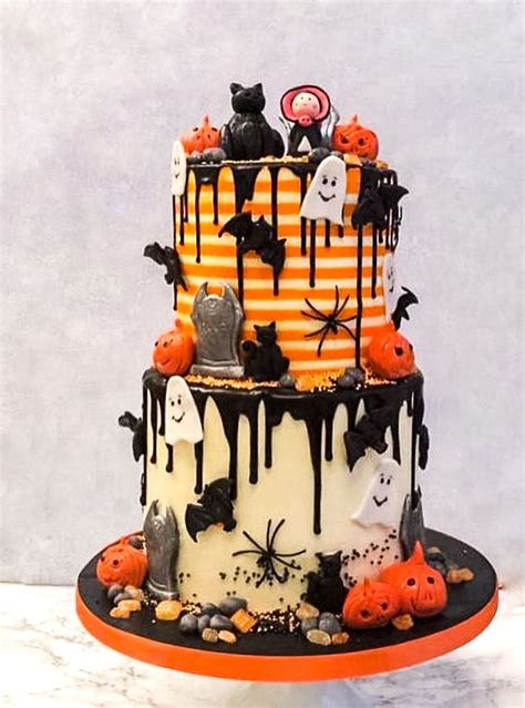 A Three Tiered Cake Decorated With Halloween Decorations