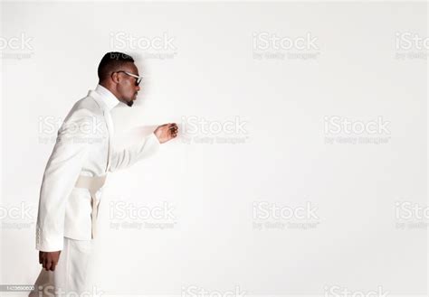 Portrait Of African Man Dressed In White With Sunglasses And Blur