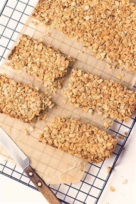 Homemade Granola Bars Sitting On Top Of A Cooling Rack Next To A Spatula