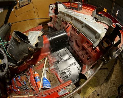 The Inside Of A Car That Has Been Stripped Off And Is Being Worked On By Someone