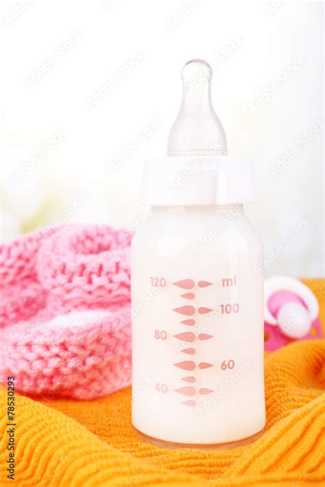 Baby Milk Bottle Pacifier And Babys Bootees Stock Photo Adobe Stock