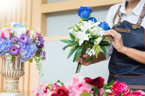 Premium Photo Midsection Of Florist Holding Flowers In Store