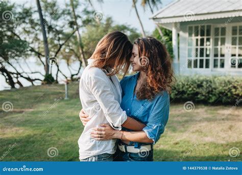 Happy Lesbian Couple Hugging In The Garden At Their Country House Stock Photo Image Of