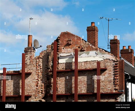 Building shored up with steelwork due to demolition and redevelopment of adjacent structure ...