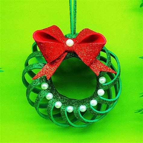 A Green Ornament With A Red Bow And Pearls