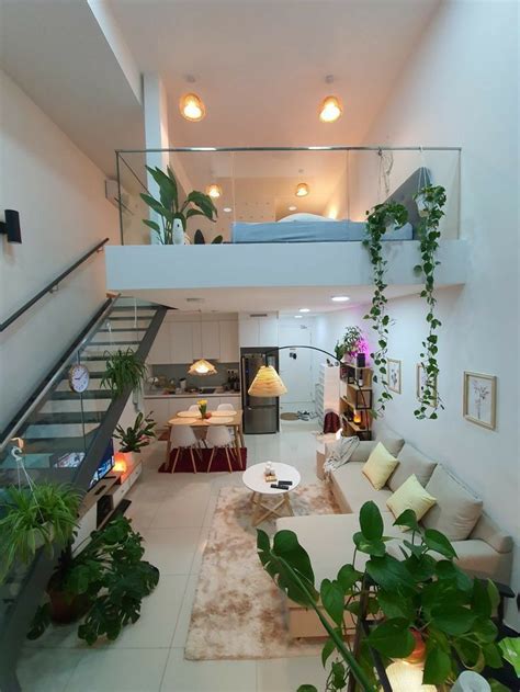 A Living Room Filled With Furniture And Lots Of Plants