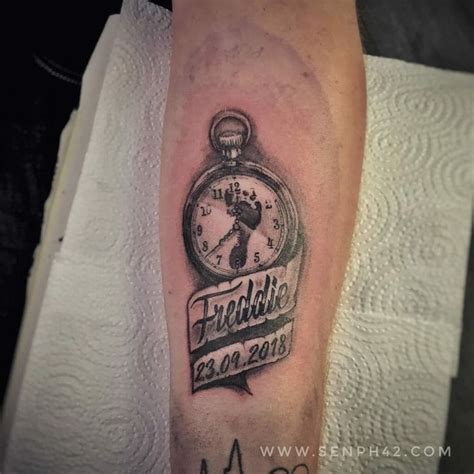 A Tattoo On The Leg Of A Person With A Pocket Watch