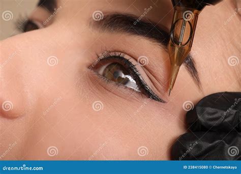 Young Woman Undergoing Procedure Of Permanent Eye Makeup In Tattoo