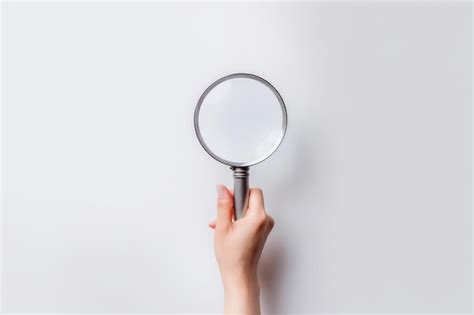 Premium Photo A Female Hand Holding A Magnifying Glass Isolated On A White Background