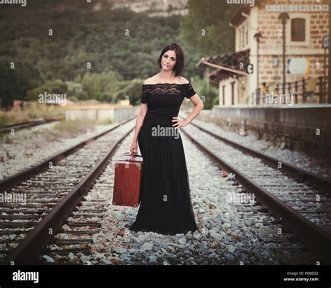 Young woman on train tracks Stock Photo - Alamy