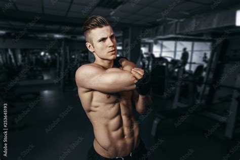 Muscular Model Young Man Exercising In Gym Portrait Of Sporty Strong