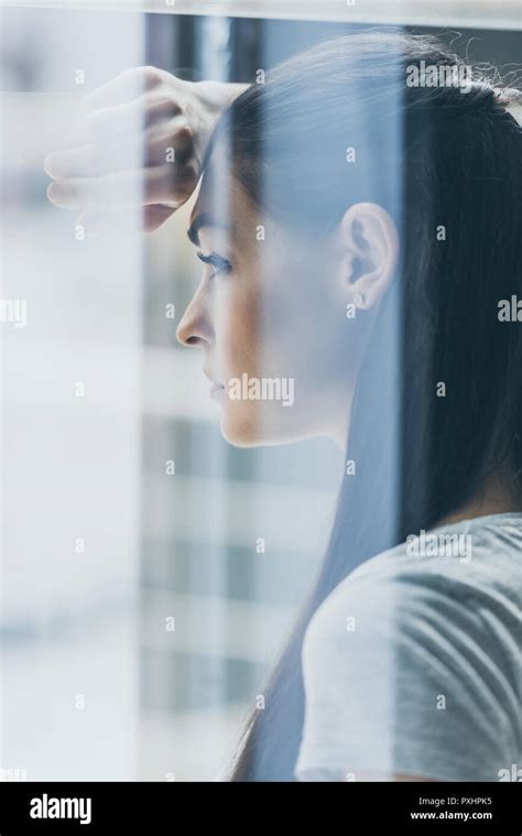 Side View Of Upset Brunette Woman Looking Away View Through Window