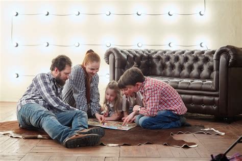 Premium Photo | Happy large family playing board game.