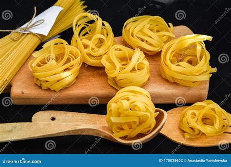 Raw Spaghetti And Tagliatelle Round Balls Of Pasta Stock Photo Image