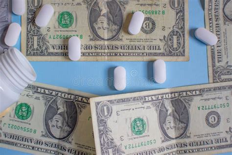 Us Dollars With Pills White Pills Spilling From A Medical Bottle Stock