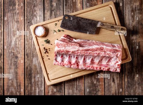 Fresh Raw Uncooked Whole Rack Of Pork Loin With Ribs On Wooden Cutting