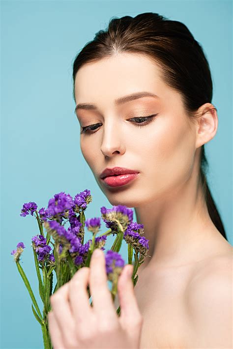 Selective Focus Of Naked Woman Near Limonium Flowers Isolated