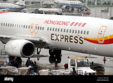 FILE Chinese Ground Crew Members Work Next To A Jet Plane Of Hong