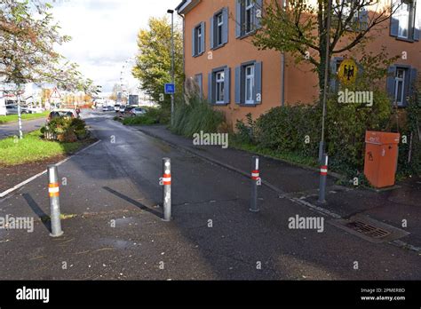 A Small Sign And An Open Road With Just Bollards To Mark The Border