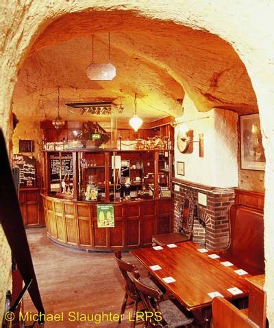 The Inside Of A Restaurant With Wooden Tables And Stools In Front Of An