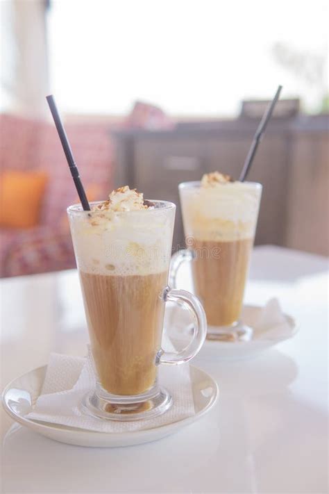 Coffee Is Served In A Tall Glass Glass With A Straw The Concept Of