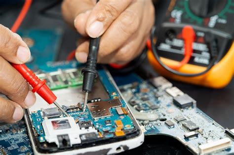 Premium Photo Technician Repairing Inside Of Mobile Phone By