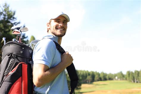 Golf Player Walking And Carrying Bag On Course During Summer Game