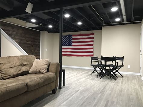 a living room filled with furniture and an american flag hanging on the ...