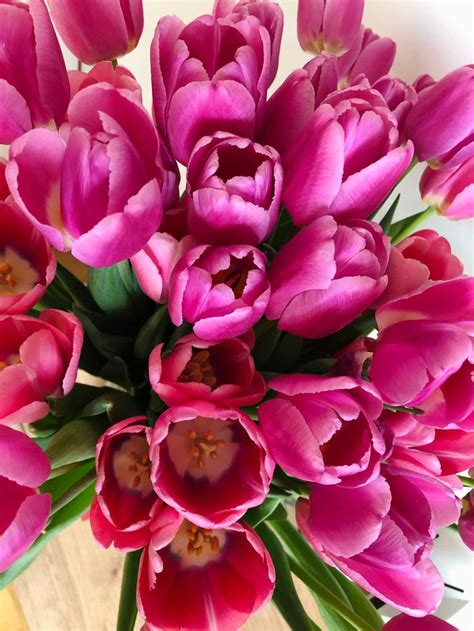 a bouquet of pink tulips sitting on top of a table