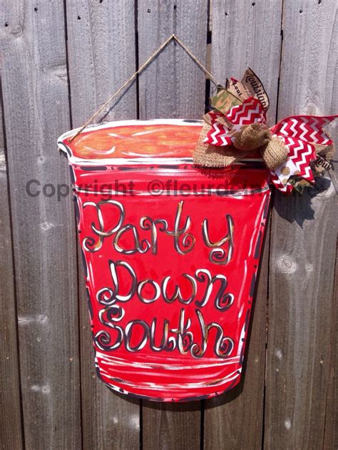 A Red Bucket Hanging On A Fence With The Words Happy Labor Day Painted