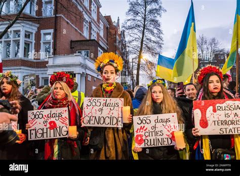 Woman With Flower Wreaths Holding Days Of War Suffering Placards At