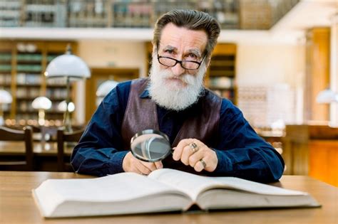 Premium Photo Elderly Man With White Beard And Glasses Working In An