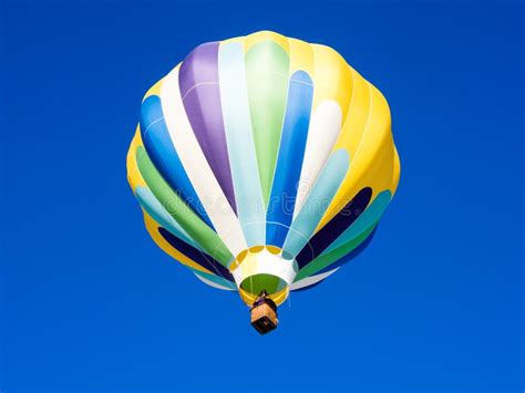 Colorful Hot Air Balloon Flying In The Bright Blue Sky Stock Photo